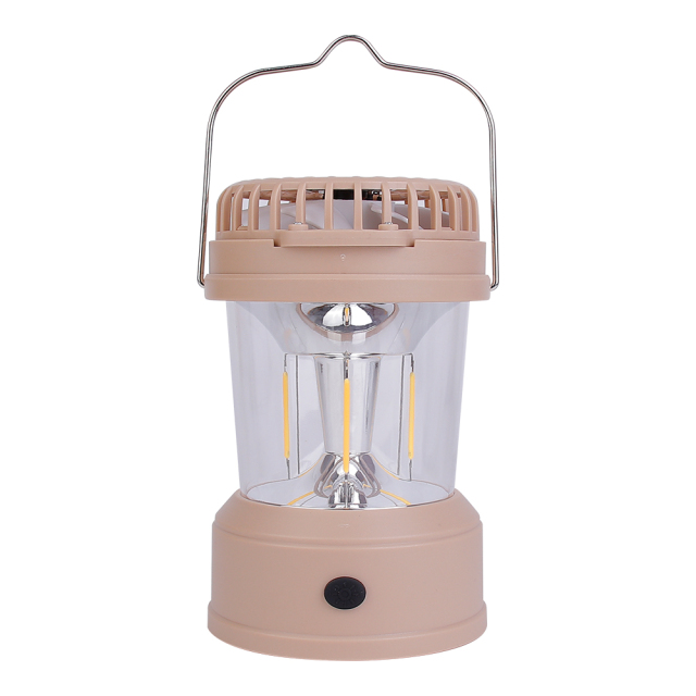 Front view of the light brown camping fan lantern on a white background with its metal wire hanging handle raised upright and top fan folded.