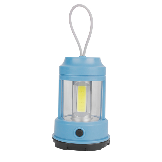 A light blue portable camping lantern on a white background with a grey silicone loop handle and a high-bright COB LED light source.