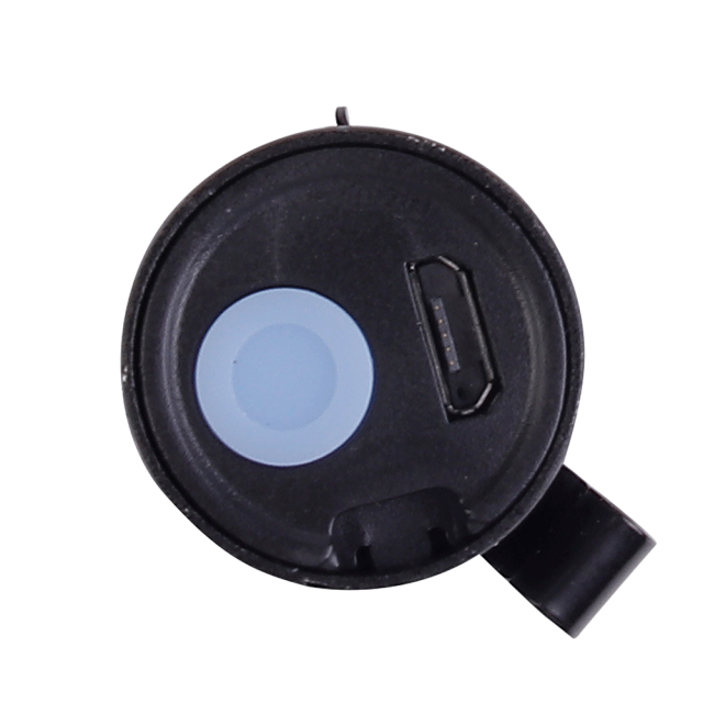 A close-up view of the flashlight tail cap showing the blue rubber push button and the integrated USB charging port.