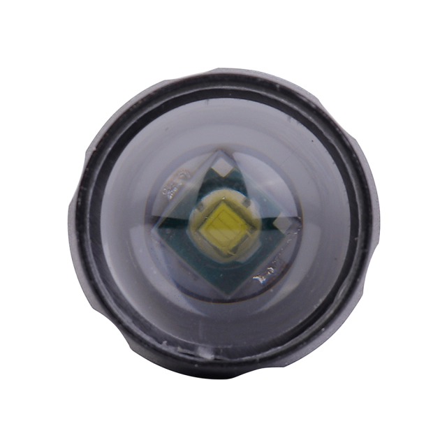A front close-up view looking directly into the flashlight head, showing the optical convex lens and 3W XPE LED emitter.