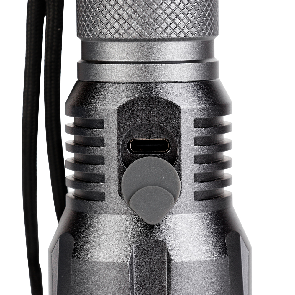 Close-up view of the rubber dust cover protecting the Type-C USB charging port on the flashlight body.
