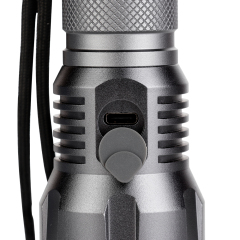 Close-up view of the rubber dust cover protecting the Type-C USB charging port on the flashlight body.