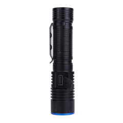 A close-up view of the tactical flashlight showing the rubber cover protecting the built-in USB Type-C charging port.
