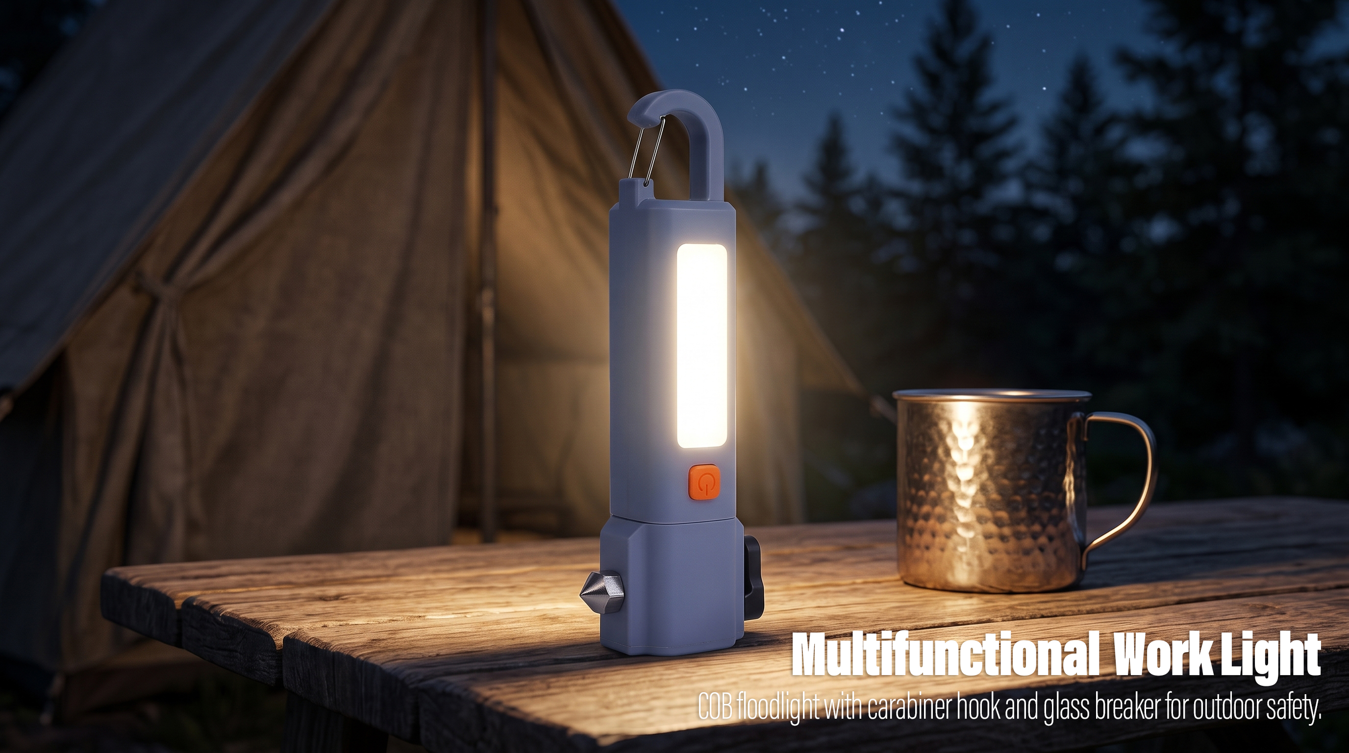 A greyish-blue multifunctional LED camping light with a carabiner hook and glass breaker standing on a wooden table near a tent at night.