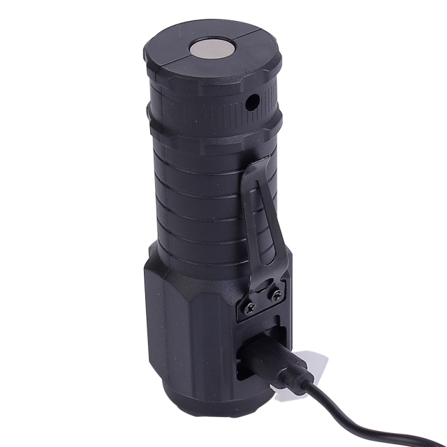 The black mini LED flashlight standing upright while connected to a Type-C USB charging cable.