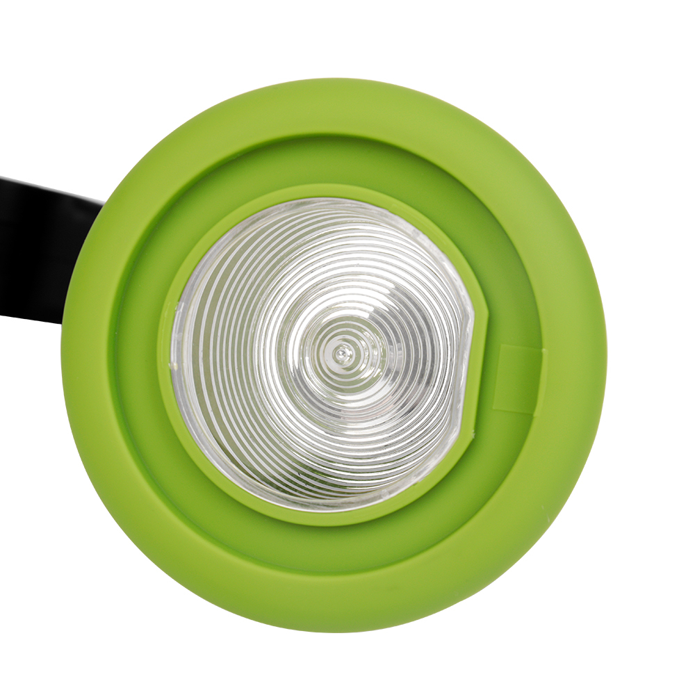 Detailed close-up of the green rim spotlight lens and ribbed reflector plate.