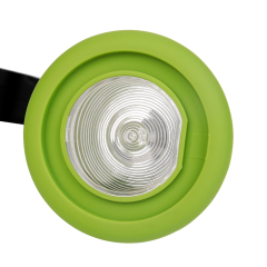 Detailed close-up of the green rim spotlight lens and ribbed reflector plate.