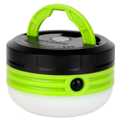 Front view of the round LED camping lantern with its green hanging handle lifted up.