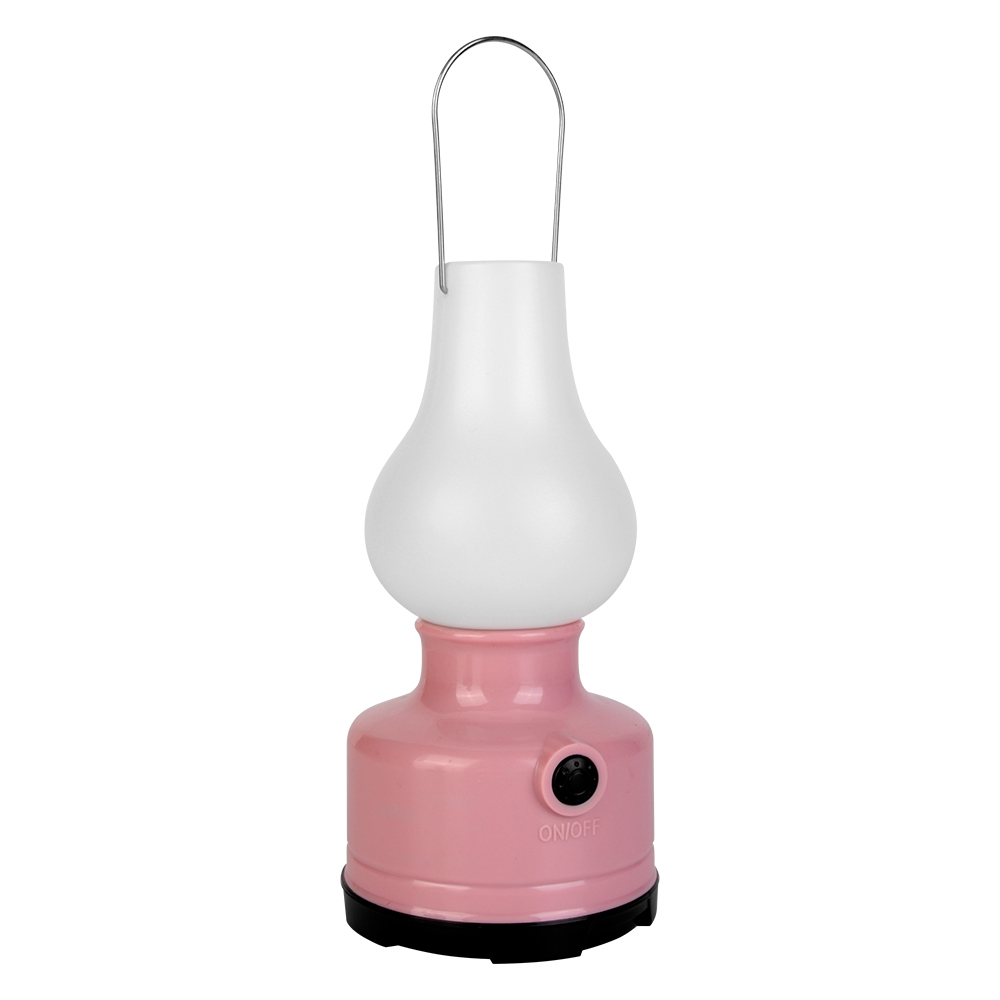 A pink vintage LED lantern with its metal hanging wire handle raised upright.