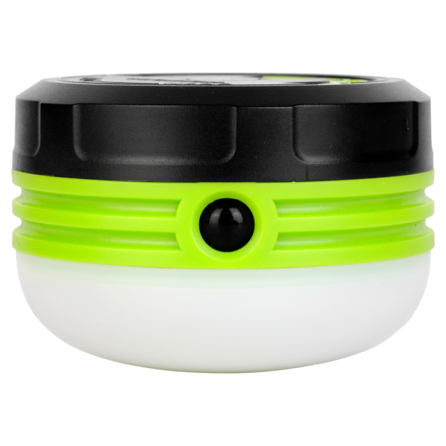 Side view of the green and black mini camping light with its handle folded down and showing the front power button.