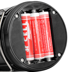 Detailed view of the opened battery compartment at the bottom with three AAA batteries installed.
