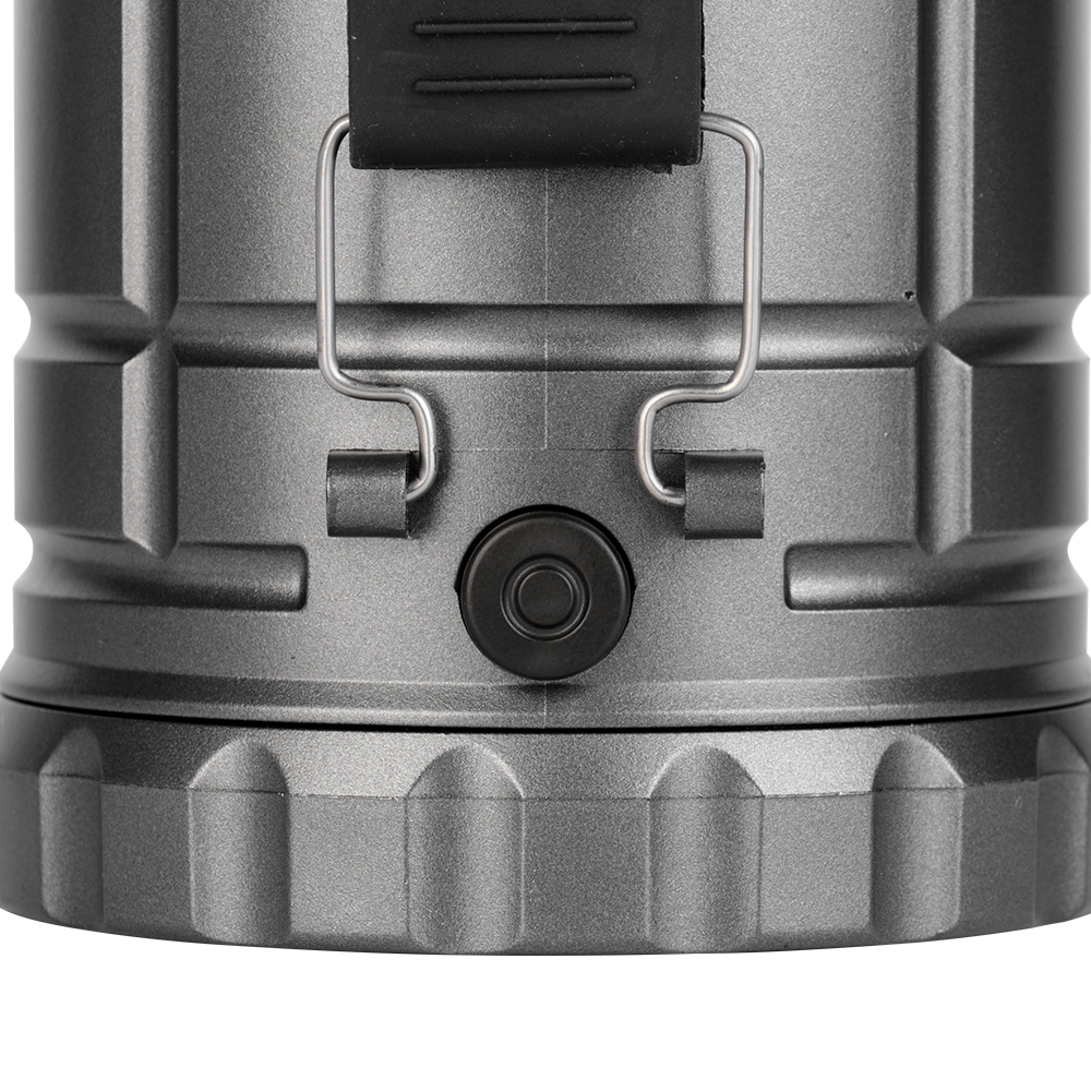 Detailed view of the rubber power button and side metal bracket attachment on the lantern body.