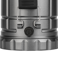 Detailed view of the rubber power button and side metal bracket attachment on the lantern body.