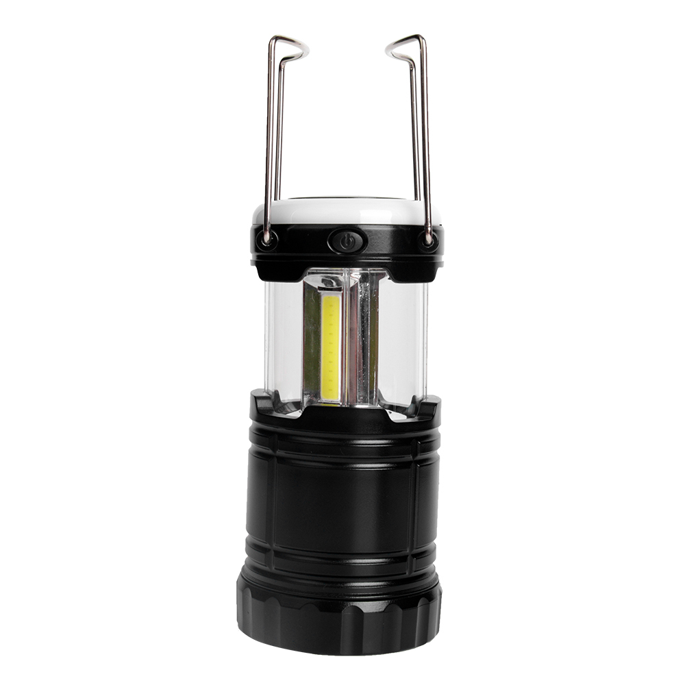 Close-up view of the extended camping lantern with its two metal hanging handles raised.