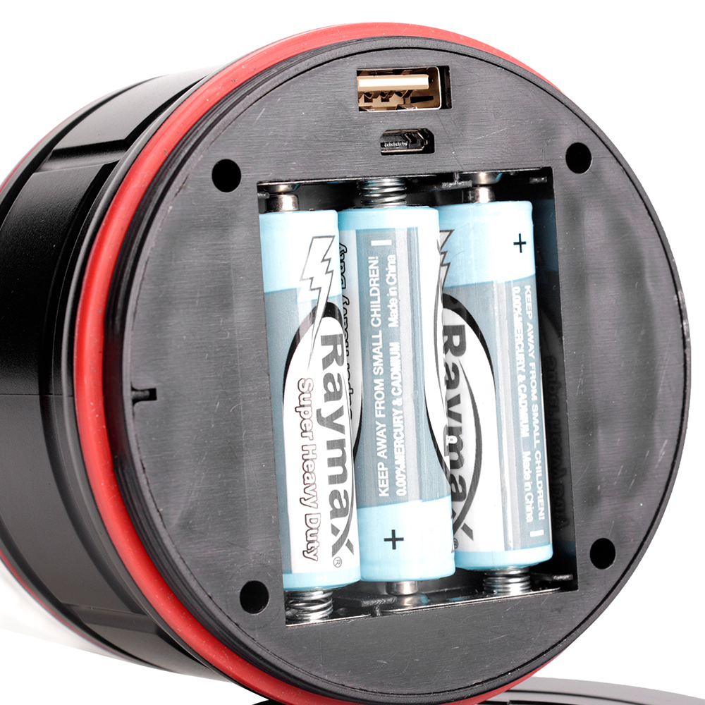 Bottom view of the camping lantern showing the battery compartment fitted with three AA batteries and a USB port.