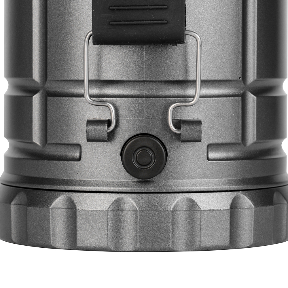 Detailed view of the push-button power switch and metal bracket attachment on the lantern body.