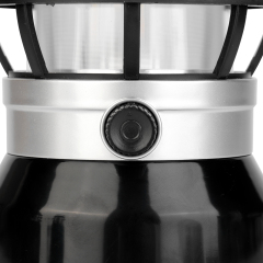 Close-up view of the rotary dimming switch knob on the metallic ring of the lantern body.
