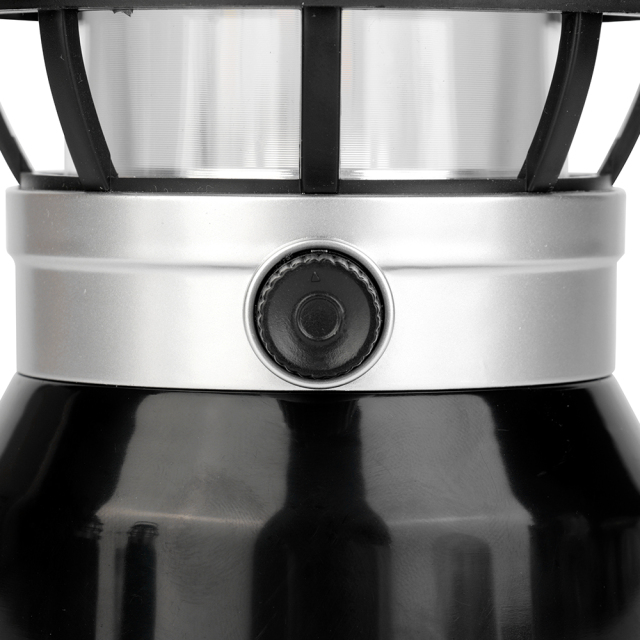 Close-up view of the rotary dimming switch knob on the metallic ring of the lantern body.