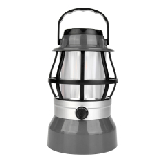 Front view of a dark grey vintage dimmable LED flame camping lantern with a top handle and black protective cage.