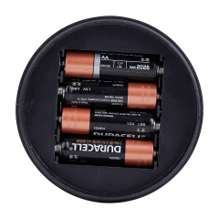 Bottom-up view of the camping light showing the battery compartment loaded with 4 AA batteries.
