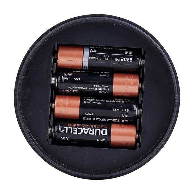 Bottom-up view of the camping light showing the battery compartment loaded with 4 AA batteries.