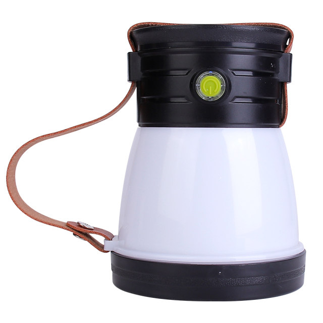 Side profile view of a white and black portable LED camping lantern with a leather strap resting along the side.