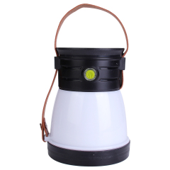 Front view of the rechargeable LED lantern standing upright with its brown leather strap raised.