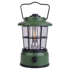 Front view of the dark green vintage LED lantern with its metal carrying handle raised.
