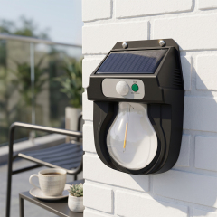 A solar tungsten bulb motion sensor wall light mounted on a white brick wall in a daytime patio setting.