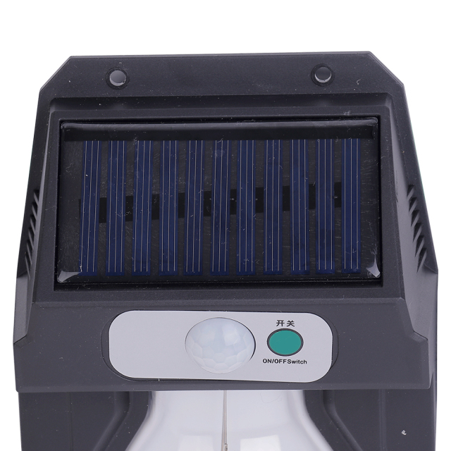 Close-up view of the top solar charging panel, motion sensor sphere, and power button on the wall light.