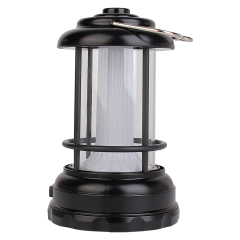Perspective view of the black vintage camping lantern featuring a push button control and top hanging ring.