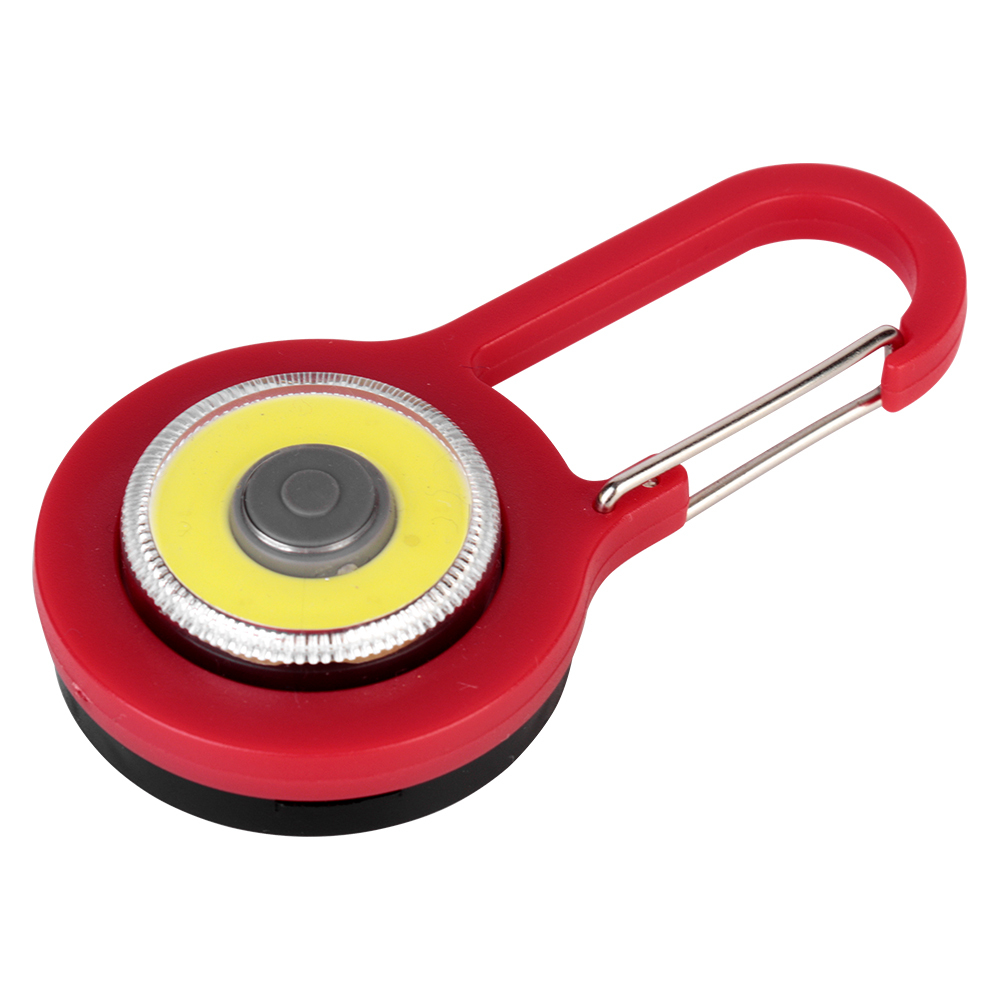 Angled view of a red mini COB LED keychain light highlighting its integrated carabiner clip.