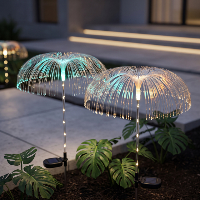 Solar optical fiber jellyfish lights with warm light reflections among monstera plants next to a set of stairs.