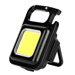 Angled view of a COB keychain light supported by its integrated 180-degree folding bracket.