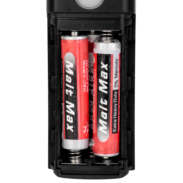 Open battery compartment of an LED bike front light loaded with AAA batteries.