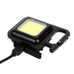 A Type-C charging cable plugged into the side port of a rechargeable COB keychain light.