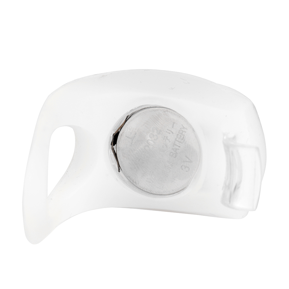 Bottom view of a silicone bike light with the cover removed to show the battery slot.