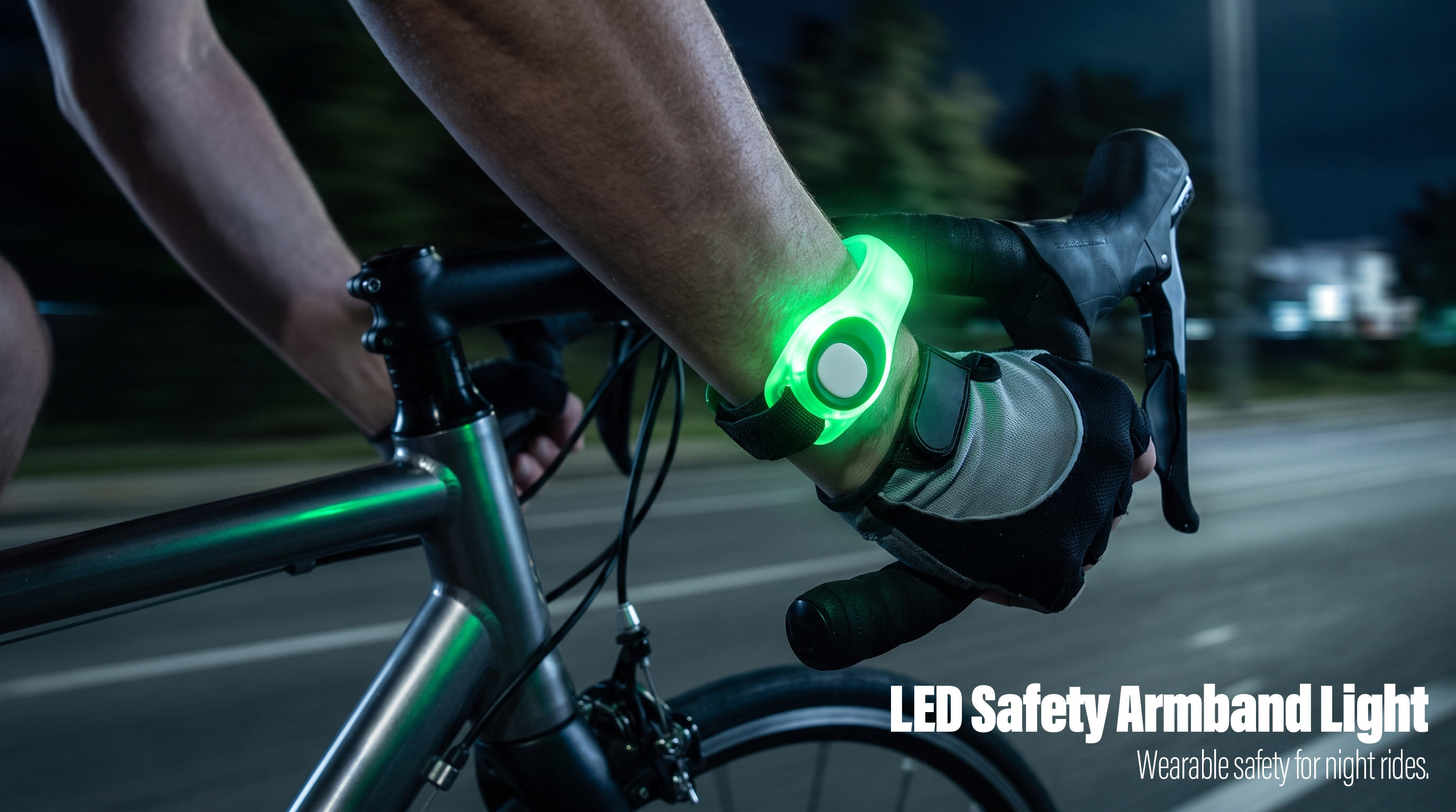 A cyclist wearing a glowing green LED safety armband light on the wrist during a night bike ride.