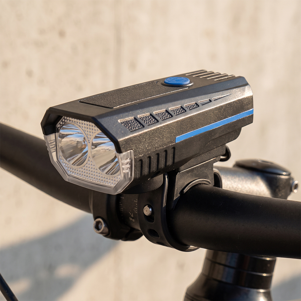 A dual-LED bike front light mounted securely on a bicycle handlebar.