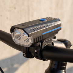 A dual-LED bike front light mounted securely on a bicycle handlebar.
