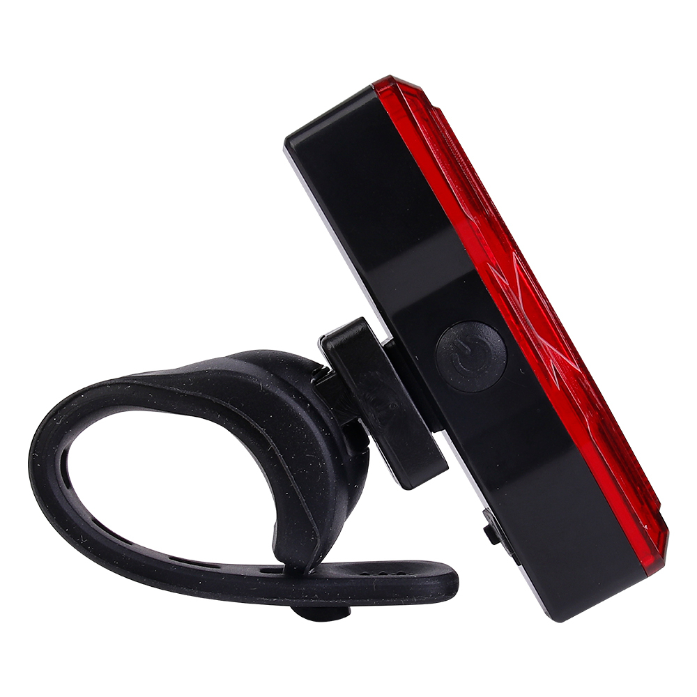 Side profile of a red bicycle tail light showing the power switch button.