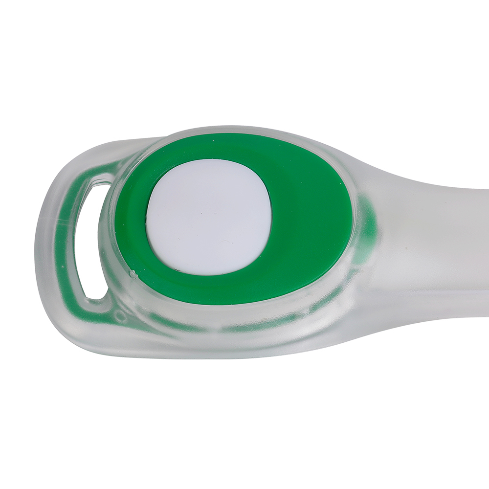 Close-up of the green silicone power button on an LED safety armband light.