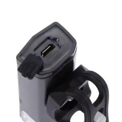 Close-up view of the Micro USB charging port with a protective rubber cover on the bike front light.