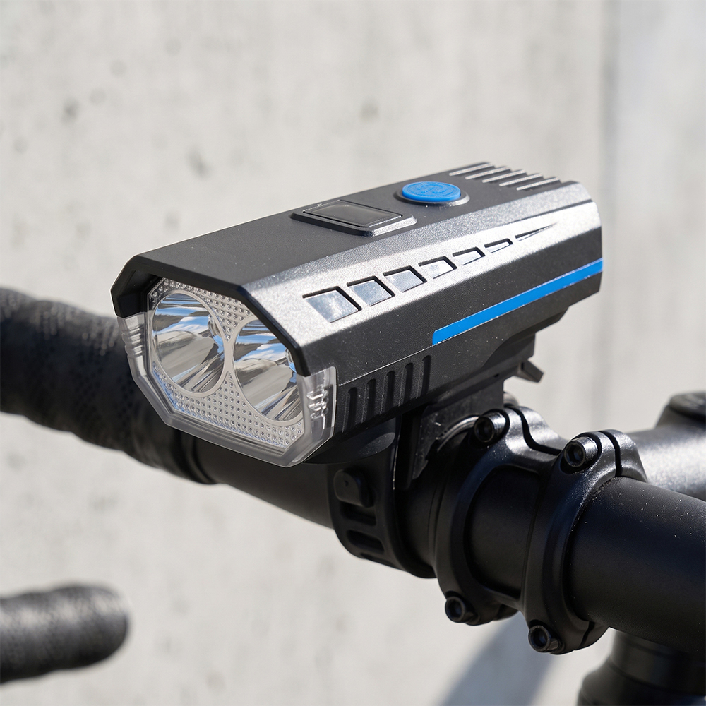 A smart display dual-LED bike front light mounted securely on a bicycle handlebar.