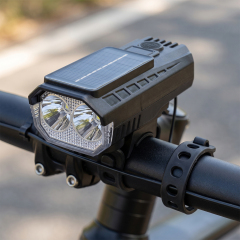 A solar-powered LED bike front light mounted securely on a bicycle handlebar.