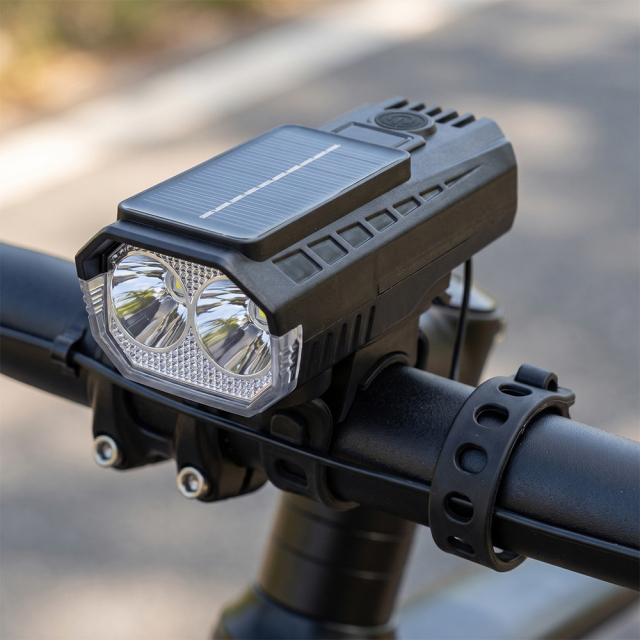A solar-powered LED bike front light mounted securely on a bicycle handlebar.