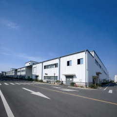 Exterior view of completed prefabricated steel industrial buildings with metal cladding and internal access roads