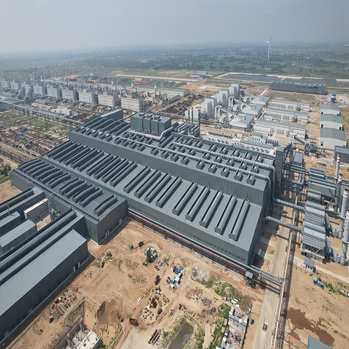 Aerial view of a large industrial steel building complex with multiple production workshops and extensive metal roofs