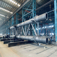 Fabrication of a heavy tubular steel truss assembly inside an industrial workshop