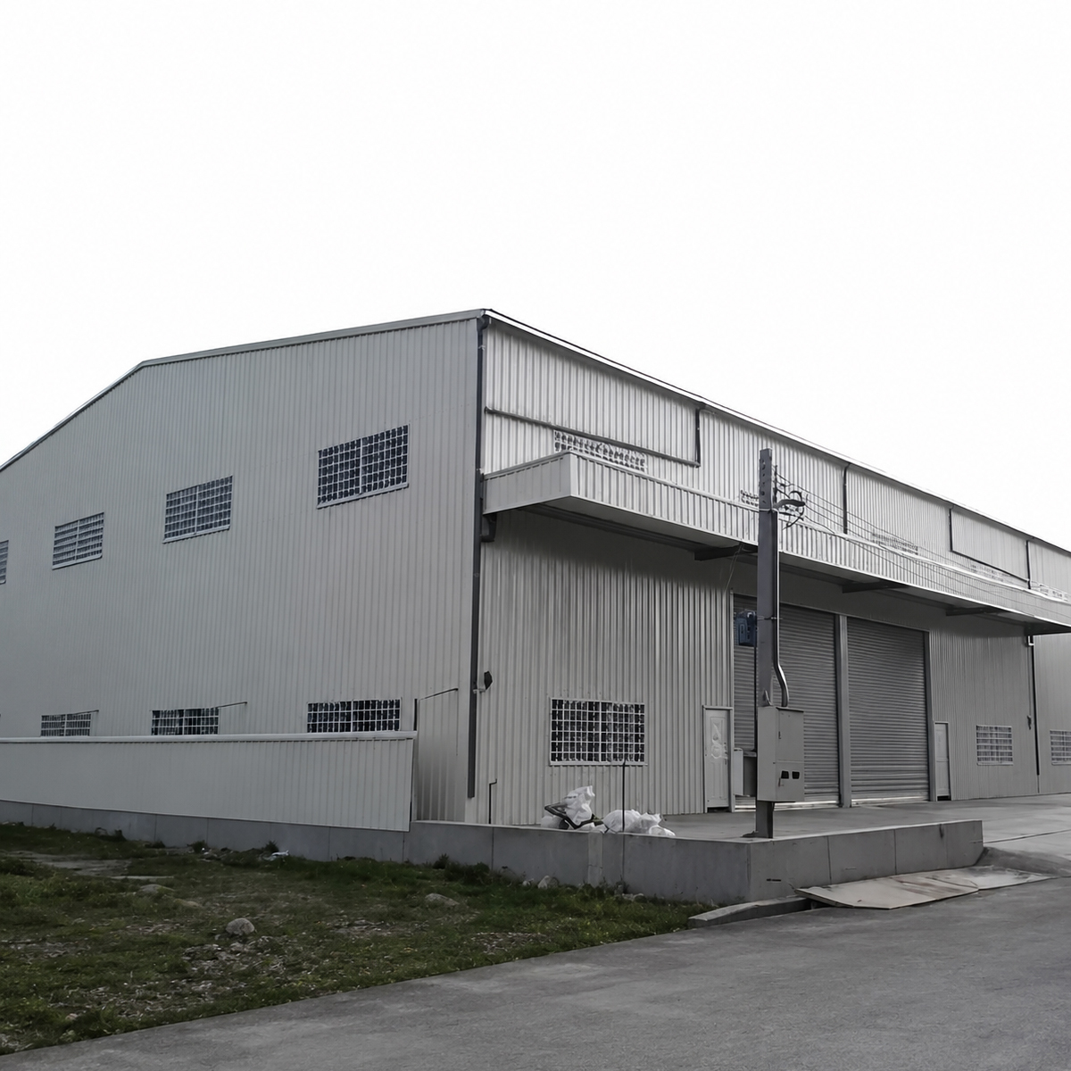 Steel structure warehouse building with metal wall panels, ventilation openings, and roller shutter doors